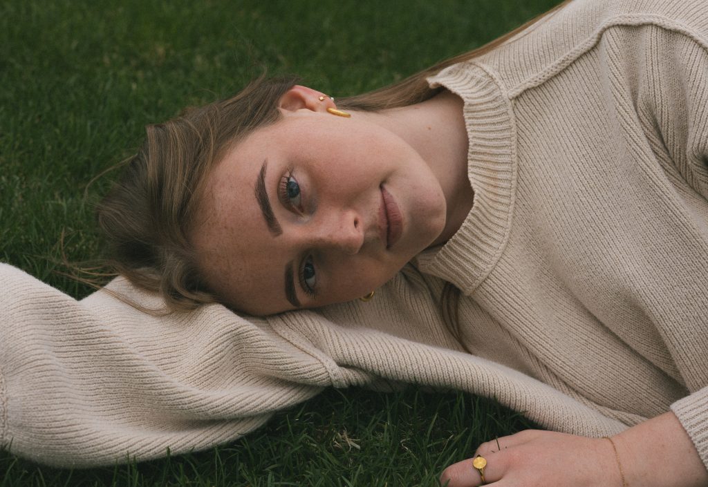 Senior portrait laying in grass