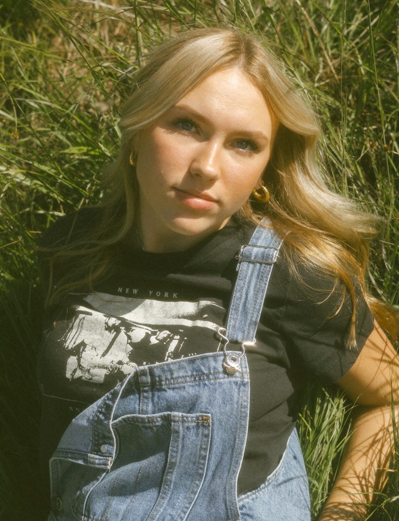 Senior portrait laying in grass