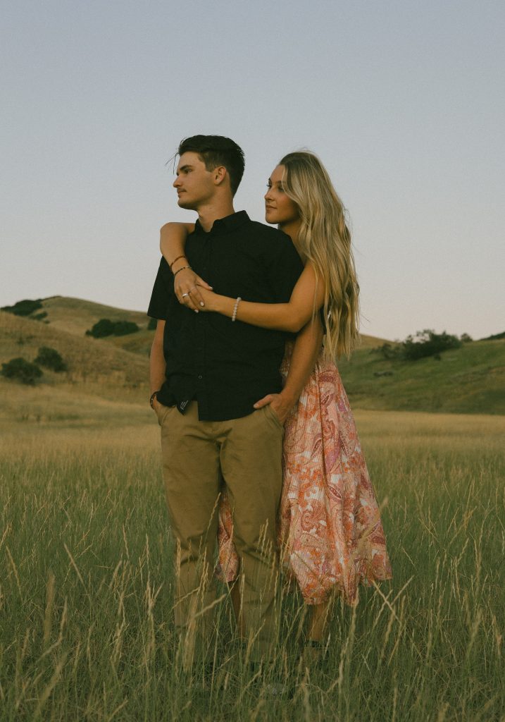 Couple embracing in field