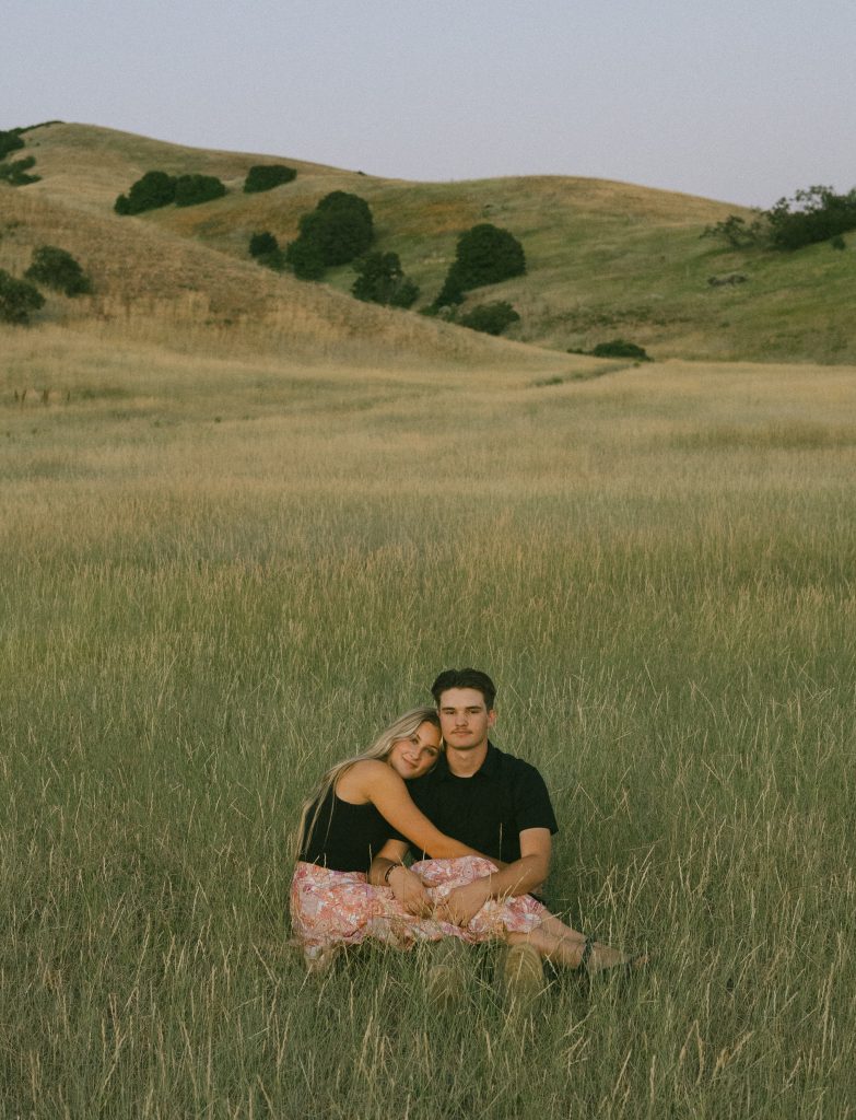 Couple sitting in field